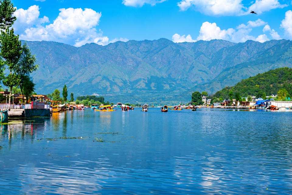 Blue water, boats and mountains around Dal Lake in Srinagar.