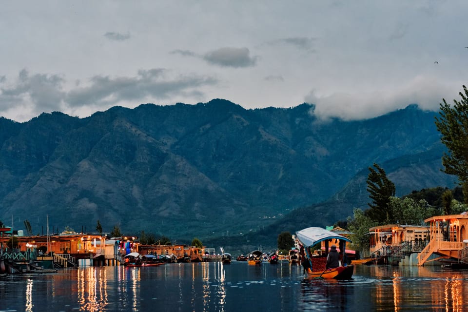 Houseboats and reflections along the edge of Dal Lake in Srinagar.