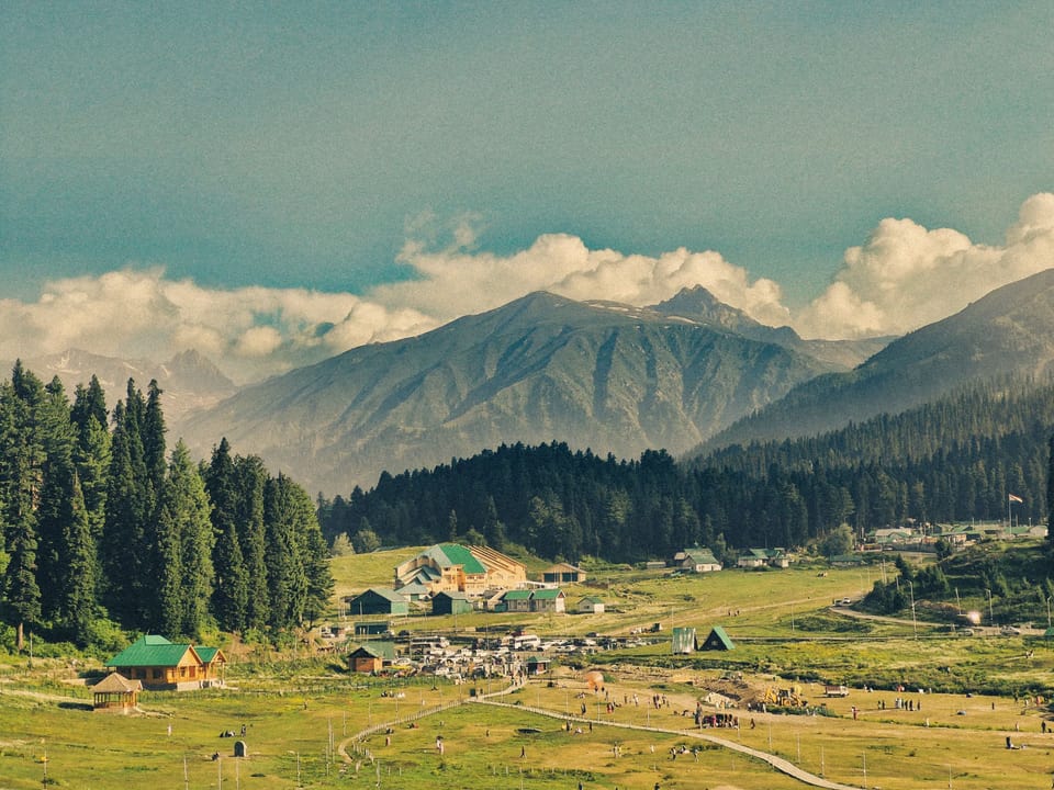 Open meadow, forest and mountain ridges in Gulmarg.