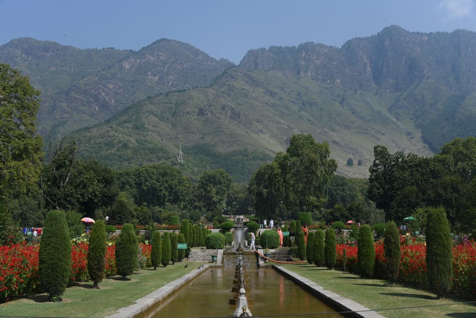 A formal watercourse and flower borders beneath the mountains at Nishat Garden.